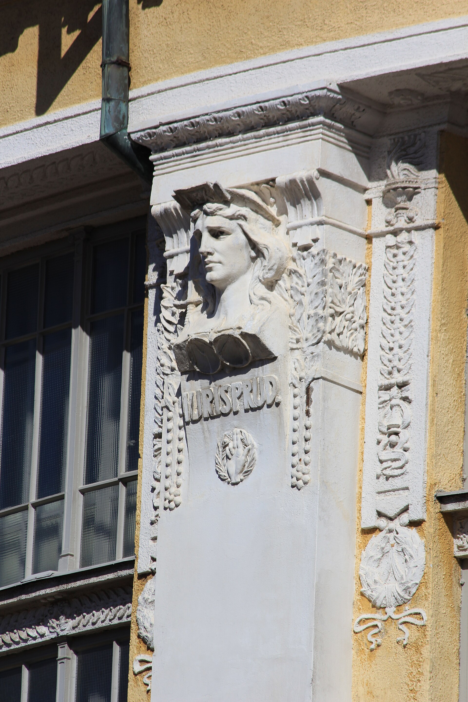 Iuris prudentia relief on the wall of rotunda extension wing of the National library of Finland. Allegory of justice, with a hand raised in oath symbol below. Sculptor Walter Runeberg (1838 - 1920).